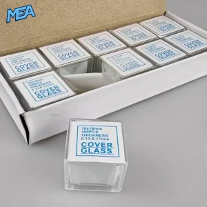 Boxed 100-piece pack of 18x18mm microscope cover glass slides next to a single stacked slide box